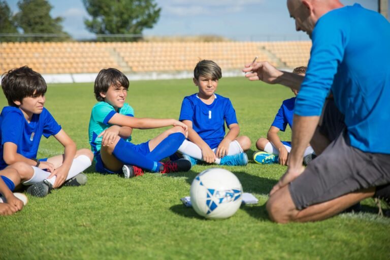 a coach conducting a soccer drill . teaching kids soccer